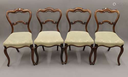 A set of four Victorian rosewood dining chairs.