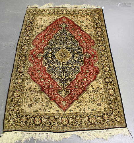 A Kashmir rug, late 20th century, the red field with a shape...