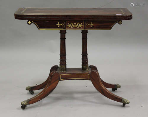 A Regency rosewood and brass inlaid fold-over card table, ra...