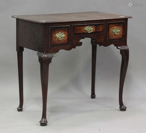 An early 18th century oak lowboy, the mahogany banded top ab...