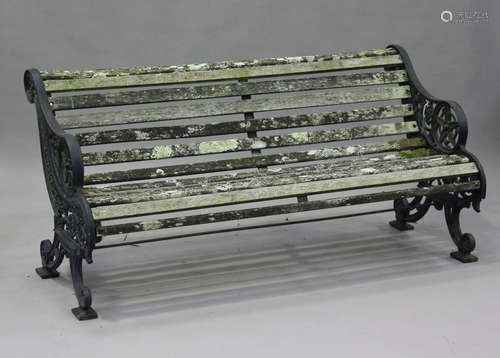 A late Victorian black painted cast iron garden bench with w...