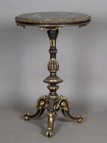A mid-Victorian ebonized and parcel gilt circular wine table...