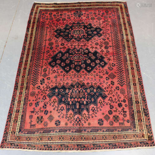 A Kurdish carpet, mid/late 20th century, the shaded pink fie...