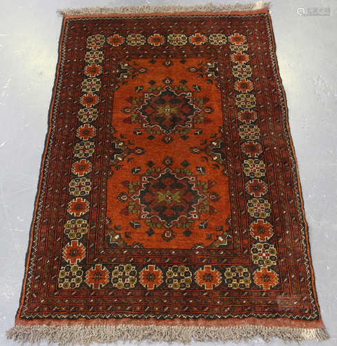 An Afghan rug, late 20th century, the chestnut field with tw...