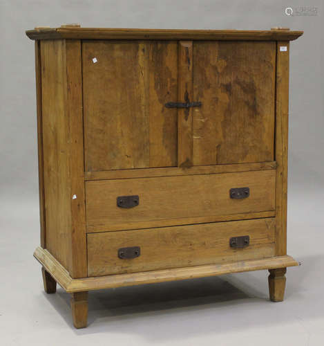 A 20th century hardwood cupboard, fitted with two doors and ...