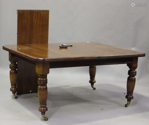 A Victorian mahogany extending dining table with single extr...