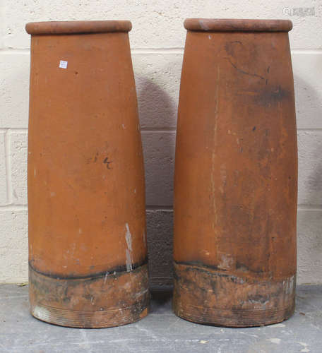 A pair of terracotta chimneys, height 77cm, diameter 30cm.Bu...