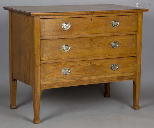 An Edwardian Arts and Crafts oak chest of drawers, in the ma...