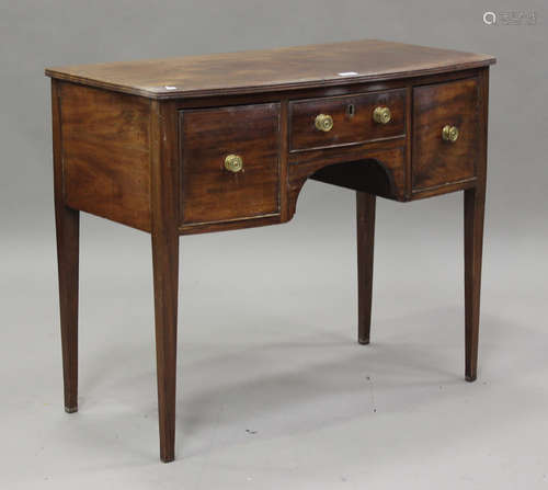 A 19th century mahogany bowfront kneehole side table, fitted...