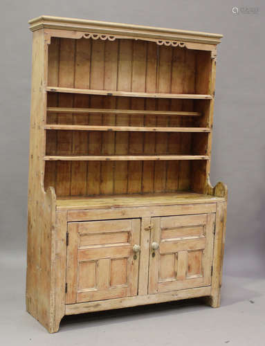 A 19th century primitive stripped pine dresser, the shelf ba...