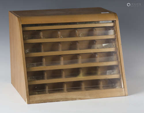 A mid-20th century counter-top haberdashery cabinet, the bac...