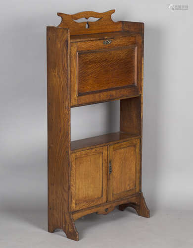 An Edwardian Arts and Crafts oak student's bureau, in the ma...