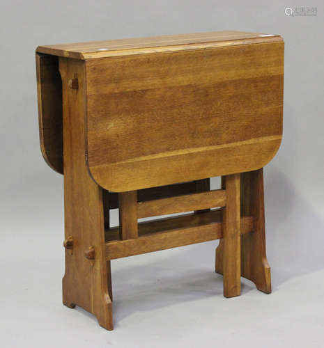 A mid-20th century Arts and Crafts style oak drop-flap table...