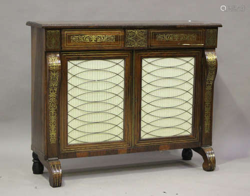 A Regency rosewood and brass inlaid pier cabinet, fitted wit...