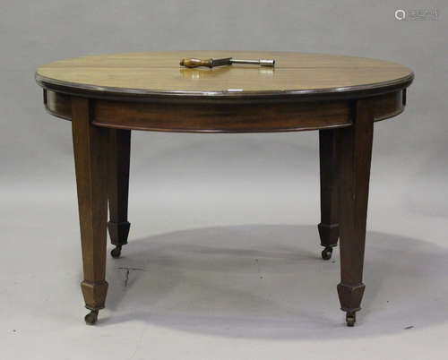 An Edwardian mahogany 'D' end extending dining table with tw...