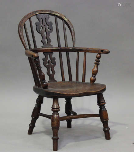 A 19th century yew and elm child's Windsor armchair, the hoo...