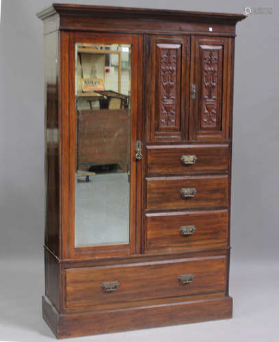 An Edwardian walnut wardrobe with carved decoration, fitted ...