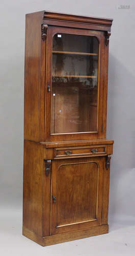 A late Victorian mahogany narrow bookcase cabinet, fitted wi...