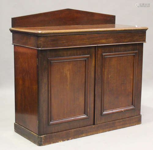 A Victorian mahogany side cabinet with arched frieze back ab...