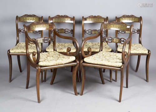 A set of twelve Regency rosewood and brass inlaid dining cha...