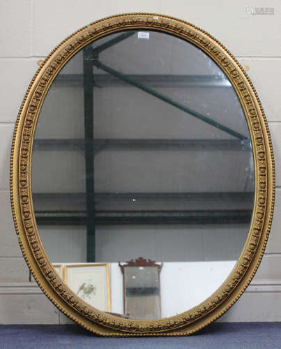 An early 20th century oval giltwood and gesso wall mirror, 1...