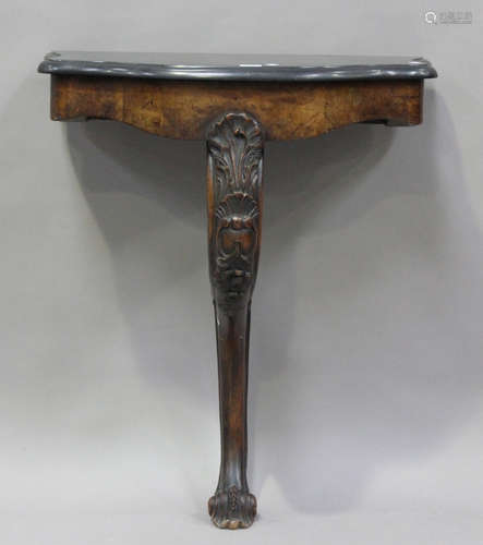 A mid-Victorian walnut console table with a shaped black mar...