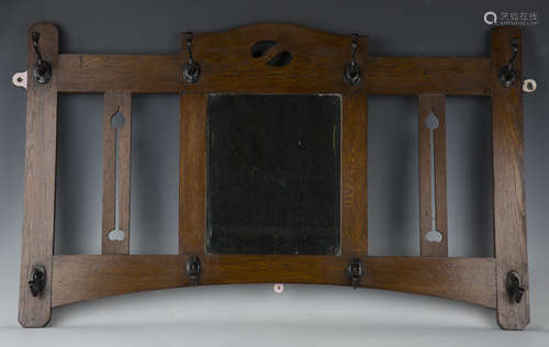 An Edwardian Arts and Crafts oak framed hall mirror, in the ...