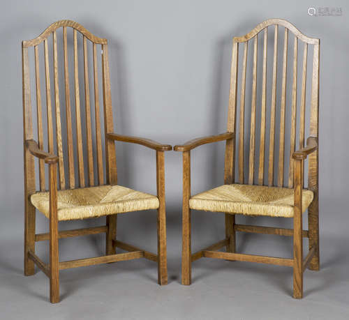 A pair of Edwardian Arts and Crafts oak framed comb back elb...