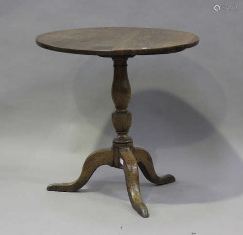 A George III oak circular tip-top wine table, the turned col...