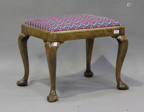 An early 20th century Queen Anne style walnut stool, on cabr...