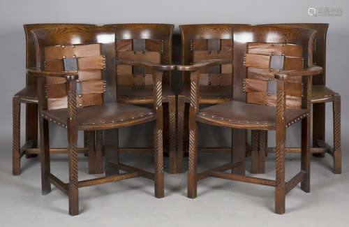 A set of six Arts and Crafts oak framed dining chairs, the d...