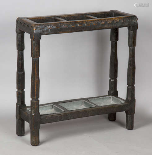 An early 20th century stained oak stick stand, possibly by R...