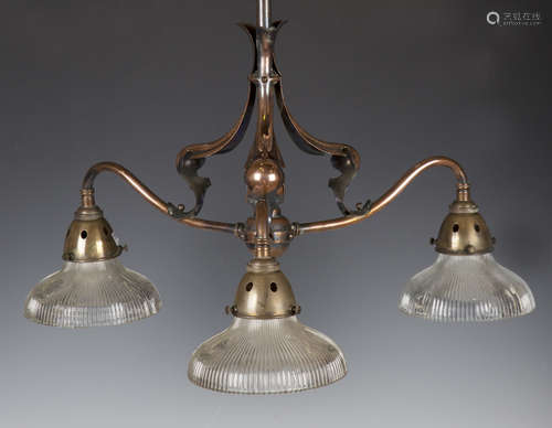 An Arts and Crafts copper three-branch ceiling light of scro...