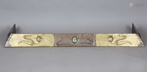 An early 20th century Arts and Crafts brass and copper fende...