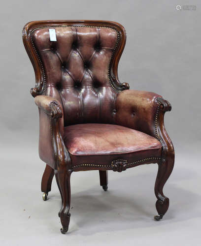 A late Victorian mahogany showframe armchair, upholstered in...