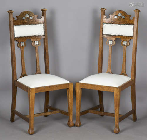 A pair of Edwardian Arts and Crafts oak framed side chairs, ...