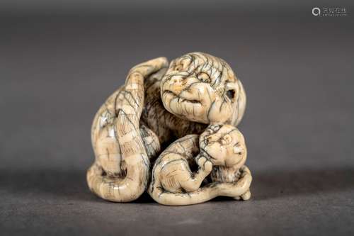 Un netsuke japonais 'tigre et petit', signé (4x4x4.5cm)