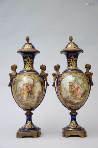 Une paire de vases en faience de Sèvres avec montures en bro...