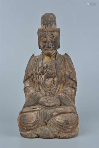 A carved wood and clay figure