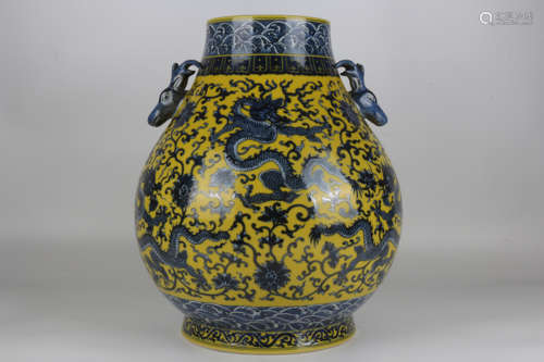 A double-eared dragon vase in blue and white on a yellow bac...