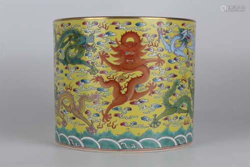 A famille-rose brush pot with nine dragons on a yellow backg...