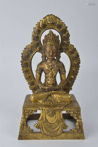 A bronze and gilt backlit Buddha statue