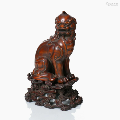 A Chinese Huang Yang hardwood carved mythical creature