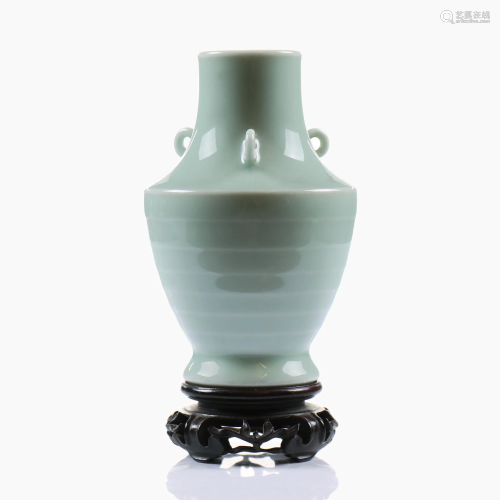 A Chinese porcelain celadon glazed vase with wood