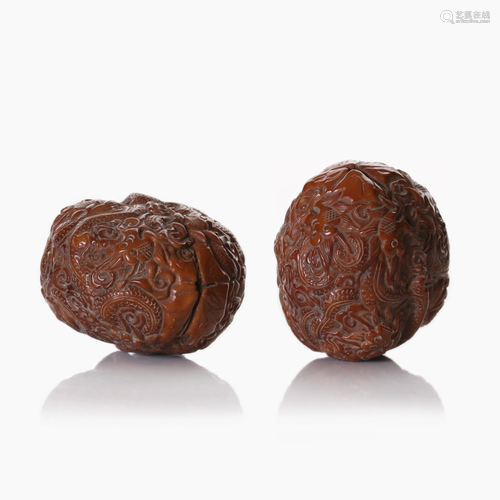 Two Chinese fully carved walnuts.