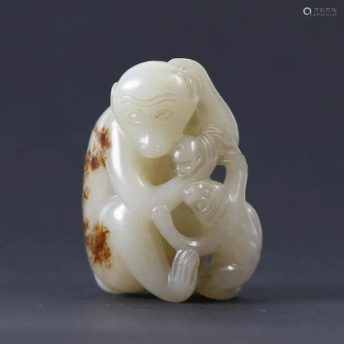 A Chinese white jade carved monkey and a baby.