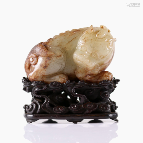 A Chinese jade carved mythical creature with wood