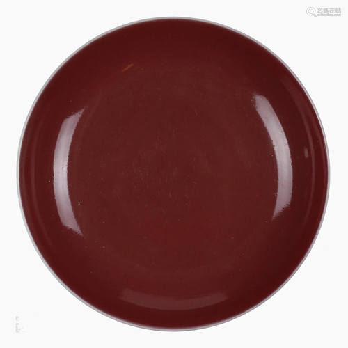 A Chinese red glazed porcelain plate.