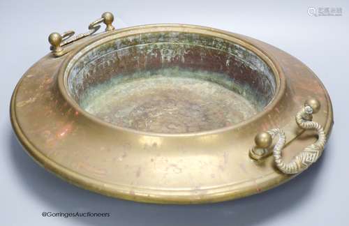 A circular brass two handled bowl, diameter 38cm