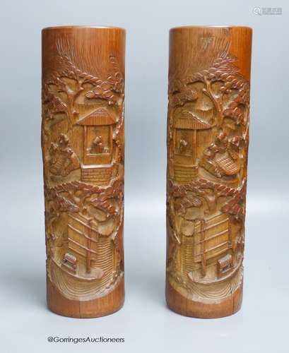 A pair of Chinese bamboo brush pots, carved with scholars in...